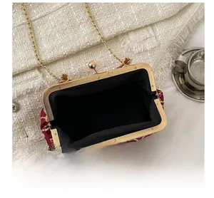 Detail view showing black lining and gold chain of the red sequin evening bag
