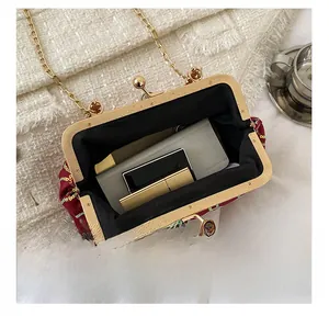 Detail of red sequined clutch bag interior showing space for smartphone and lipstick