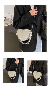 Chic silver sequin heart bag shown with a metal chain strap and top handle detail