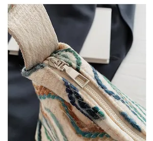 Close-up of silver metal zipper and woven fabric texture on a bohemian tote bag