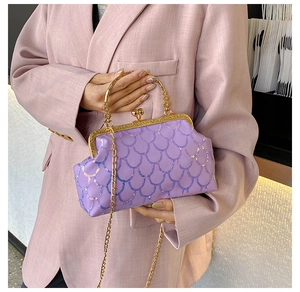 Detail of light purple sequin evening bag with gold chain and fish scale texture
