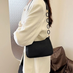 Minimalist black woven underarm bag with decorative resin chain strap for women