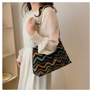 Detail of bohemian tote bag featuring colorful wavy patterns and a wide embroidered strap