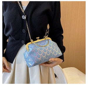 Detail of light blue sequin evening bag with fish scale pattern and gold chain strap