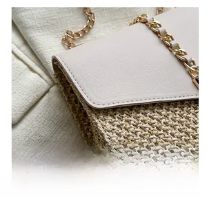 Detail showing high-quality stitching on the leather flap of the straw woven crossbody bag