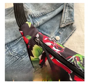 Close-up of smooth black zipper and vibrant floral pattern on the shoulder bag