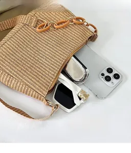 Internal view of a woven crescent bag showing storage space for phone and sunglasses