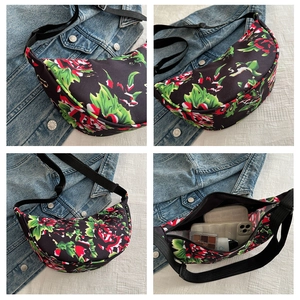 Detailed interior of floral crescent crossbody bag showing spacious storage for phone and makeup