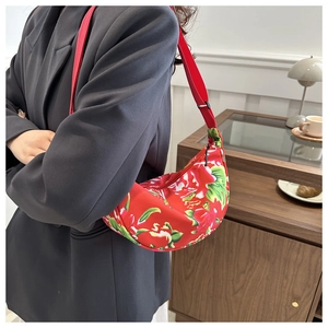 Detailed shot of a red floral hobo bag featuring traditional Chinese peony patterns