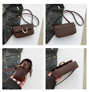 Detailed views of dark brown faux crocodile leather bag with gold metal buckle