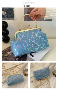 Close-up of blue sequin evening bag with gold floral handle and metal chain strap