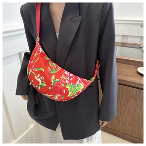 Chinese red floral crossbody bag shown on model with adjustable strap for casual style