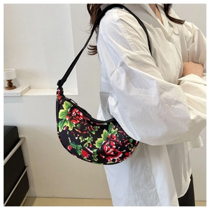 Detail of vintage floral shoulder bag with red rose pattern and adjustable strap