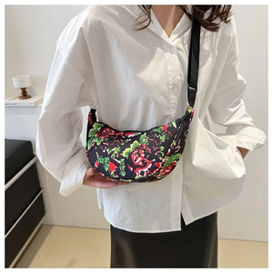 Floral half-moon crossbody bag with red rose pattern and adjustable black strap