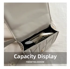Internal capacity view of beige quilted handbag showing phone, wallet and cosmetics