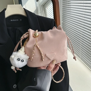 Borsa a secchiello rosa con coulisse, tracolla a catena dorata e ciondolo a agnello