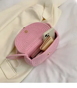 Detailed interior of pink woven shell bag with gold magnetic snap and storage space