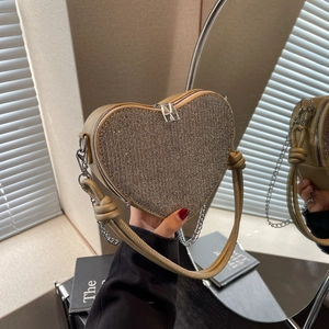 Champagne gold heart-shaped evening bag with shimmering rhinestones and chain strap