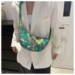 Detail of green floral crescent bag featuring traditional Chinese pattern and nylon texture