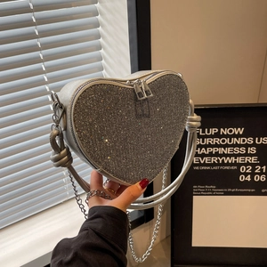 Sparkling silver heart-shaped sequin crossbody bag with chain strap and knot handle