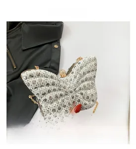 Close-up of butterfly evening bag with silver rhinestones and gold clasp detail