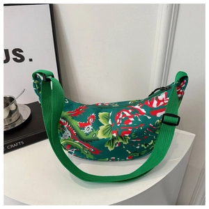Detail of green floral canvas crescent bag with traditional Chinese dragon patterns