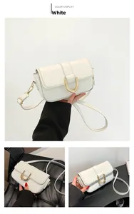 Detail showing the white crocodile pattern PU leather with a gold U-shaped metal buckle