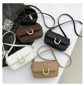 Detail view of crocodile pattern faux leather flap bags in four stylish colors with gold buckles