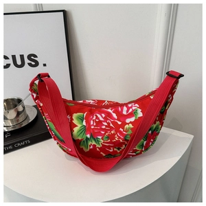 Detail view of red Chinese ethnic floral crossbody bag with peony patterns and nylon strap