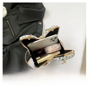 Macro view of butterfly clutch interior showing capacity for phone and lipstick