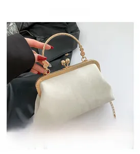 Detail view of marble pattern clutch with vintage gold handle and floral carvings