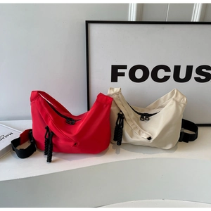 Minimalist nylon crescent bags in red and off-white with sport-chic woven zipper pulls