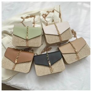 Detailed view of woven straw crossbody bags with leather flaps and gold chains in five colors