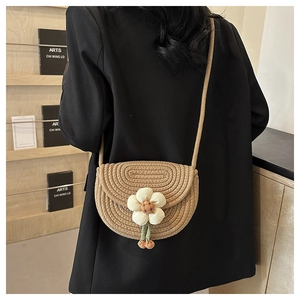Detailed shot of handmade woven mini bag with 3D white flower on beige cotton rope
