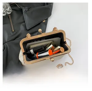 Top view of open beige leather chain bag showing interior capacity with daily essentials