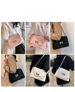 Detailed comparison of pink, black and white minimalist shoulder bags with bow metal clasp