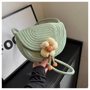 Detail of light green hand-woven mini shell bag with 3D flower and spiral texture