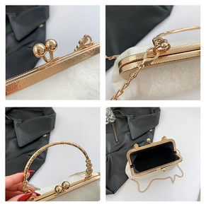 Detail view of pearlescent evening bag featuring carved metal kiss-lock and ring handle