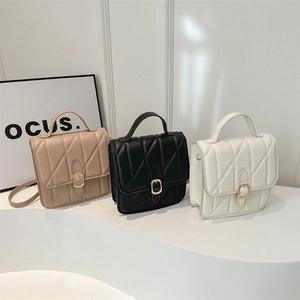 Quilted flap handbag in milk tea, black, and white with golden buckles and straps