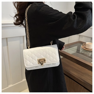 Détail du sac bandoulière matelassé blanc avec fermoir doré et bandoulière en chaîne