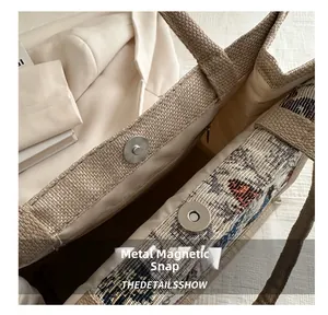 Detail showing the metal magnetic buckle and interior zipper pocket of this retro tote bag