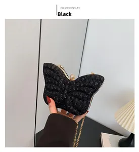 Detail of butterfly-shaped black sequin evening bag with gold frame and chain strap