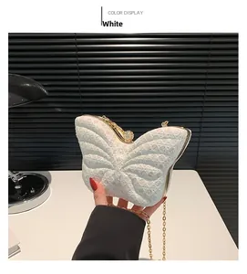 Detail of white sequin butterfly handbag with golden chain and diamond buckle