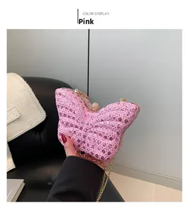 Detailed macro view of pink butterfly sequin clutch bag with metal chain and crystal lock