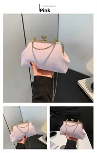 Detail view of pink textured evening bag with gold metal frame and pearl clasp closure