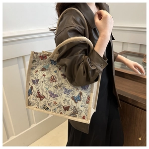 Detail view of retro canvas tote bag with colorful butterfly prints on thick fabric