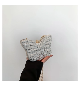 Detail of glittery butterfly evening bag with silver rhinestones and pearl clasp