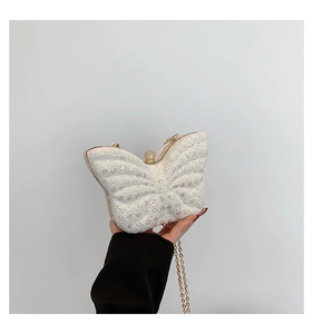 Detailed view of butterfly evening bag with sequins, gold frame, and jeweled clasp