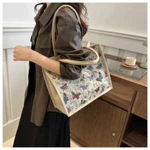 Detail view of the large capacity canvas tote bag featuring colorful butterfly print