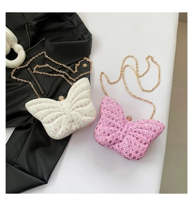 Macro shot of sequined butterfly chain bags in white and pink with diamond clasps